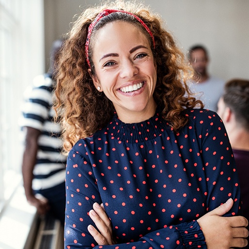 Woman with white straight teeth smiling at work