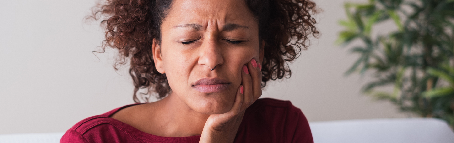 Woman holding her cheek in pain