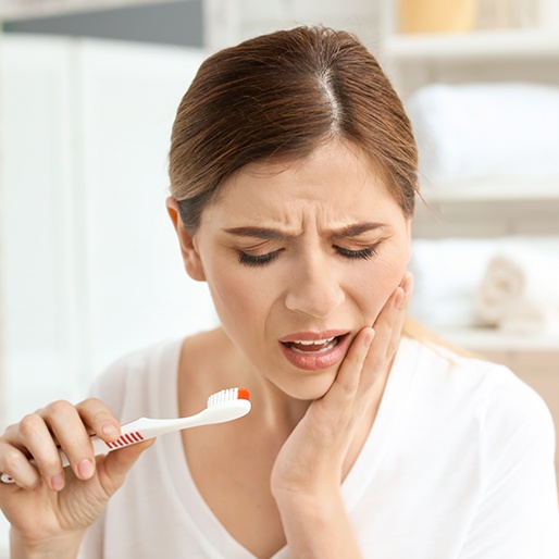 Woman holding her jaw in pain