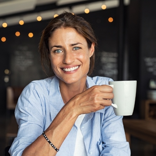 Woman smiling after dental implant tooth replacement