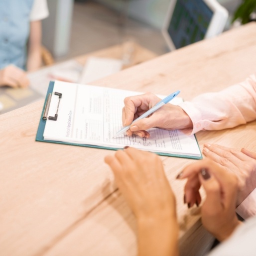 Dental patient reviewing treatment plan and expense forms