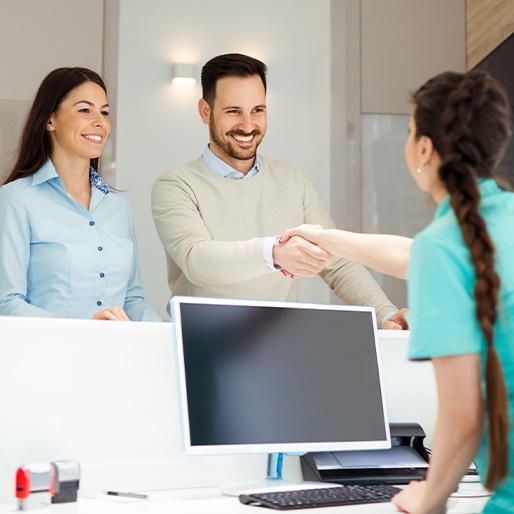 Two patients checking in at dental office front desk