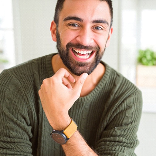 Man in green sweater smiling