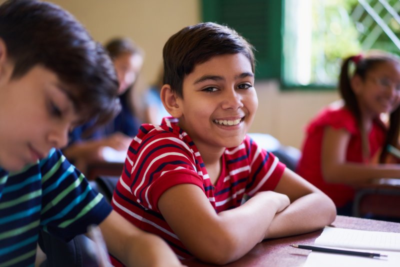 young boy smiling in school