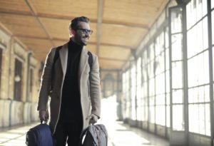 Smiling man carrying luggage 